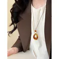 Amber resin hollow circular pendant necklace for women retro style long sweater chain - Coffee