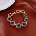 Vintage gold bracelet featuring deep blue gemstones and clear crystal accents - Floral Rhinestone Bracelet (66#) / Gold-Blue