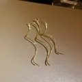 Close-up of elegant gold-plated wavy ear threads with shimmering metallic texture - Gold