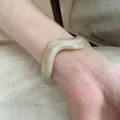 Minimalist irregular acrylic bangle with cream marbled swirl pattern on model wrist - Wave Style (57#)