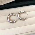 Close-up of elegant silver C-shaped hoop earrings displayed on a soft jewelry tray - Style 5 / 3cm / Silver