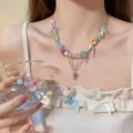 Vibrant candy colored beaded necklace with metallic tassels and sweet Y2K bow charm - Multicolor (Silver Bow Pendant)