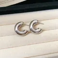 Detail of chunky silver-toned C-shaped stud earrings on a beige velvet tray - Style 4 / 2.5cm / Silver