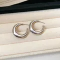 Close-up detail of minimalist silver-tone C-shaped hoop earrings on velvet tray - Style 6 / 3cm Slim / Silver