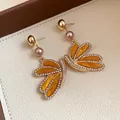 Vintage gold butterfly earrings with pearls and rhinestones on textured white tray - Butterfly-Shaped Pearl Necklace (89#) / Gold Brown