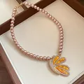 Elegant vintage style pink pearl necklace featuring a large rhinestone butterfly pendant - Butterfly Pendant Pearl Necklace (90#) / Gold Brown