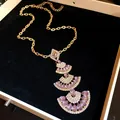 Elegant gold-tone necklace with tiered fan-shaped purple gemstone pendant - Necklace / Purple