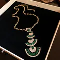 Detailed view of luxury tiered fan-shaped necklace featuring green and white gemstones - Necklace / Green