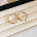 Minimalist gold round hoop earrings presented in a premium beige velvet jewelry case. - Style(55#) / 30MM / Gold