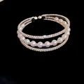 Close-up of elegant three-layer open bangle with shimmering rhinestones and pearls - Basic Three-Layer Open Style / Silver
