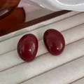 Close-up detail of elegant glossy deep red oval stud earrings inside a jewelry box - 55# Silver Needle - Red