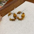Macro detail view of vintage beaded circular stud earrings with silver accents - Beaded Round Patchwork Style (WE5303) / Silver and Coffee