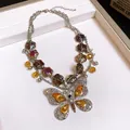 Close-up of a vintage multi-layered necklace featuring an ornate rhinestone butterfly pendant. - Silver (AB Color)