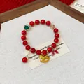 Detailed view of an elegant red beaded bracelet featuring a golden rocking horse charm - Style 6 / Red