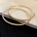 Elegant oversized gold-tone hoop earrings adorned with sparkling pavé rhinestones - Gold Full Zirconia Hoop / 8.5cm / Gold