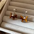 Elegant silver needle rocking horse pendant earrings with brown shimmer and diamond accents - Drop Wood Horse (45#)