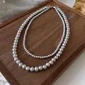 Detailed view of a French retro double-layer pearl necklace displayed on a wooden tray. - 8mm Gray Double Layer (24#) / Gray