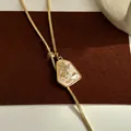Detailed view of adjustable gold-plated snake chain necklace with irregular pendant - Gold