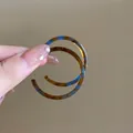 Close-up of vintage leopard print hoop earrings with blue and brown patterns - Colorful Leopard Large Hoop Earrings / Coffee and Blue