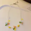 Colorful beaded necklace with sweet floral charms and clear faceted beads. - Colorful Beaded