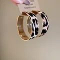 Vintage leopard print fabric hoop earrings with an elegant gold finish metal trim detail - Gold Edged Leopard Hoop / Gold & Coffee