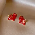 Elegant red enamel horse earrings with gold wings on silver needles for daily wear - Red + Gold