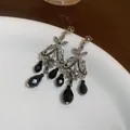 Elegant vintage silver-toned dangle earrings featuring faceted black teardrop beads and stones. - Style 21#