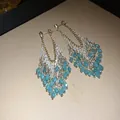 Teal glass teardrop tassel dangle earrings with gold and silver tone accents - White-Blue
