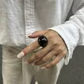 Minimalist black glossy resin square ring displayed on finger, high-end niche jewelry - Black
