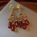 Vintage gold chandelier earrings with amber teardrop tassels and zircon accents. - Style 67