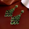 Elegant gold chandelier earrings with cascading emerald green pear-cut stones. - Style 6 Tassel