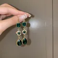 Elegant vintage gold drop earrings with faceted emerald green crystals and zircon details. - Style 9 Tassel