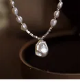 Detail shot of irregular Baroque pearl necklace with lustrous water-drop pendant - Necklace (HN5673-1) / White