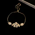 Macro view of vintage gold bracelet featuring a detailed sparkling zircon rose pendant - Flower Pendant Style / Gold