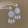 Close-up of silver-tone chandelier earrings with sparkling marquise crystal tassels. - Round Wheel Marquise Pendant (71#) / Silver