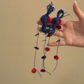 Macro view of long bohemian dangling earrings with blue ropes and red shell discs - Woven Round Style (15#)