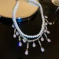 Detail view of a multi-layer pearl necklace with sparkling teardrop rhinestone charms. - Silver Teardrop Pearl Tassel Necklace
