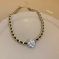 Elegant detail of French style gold interwoven chain necklace with camellia flower pendant - Camellia Woven Necklace / Gold