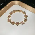 Close-up of vintage French gold floral bracelet with sparkling pink rhinestones - Bracelet-Gold-Pink