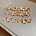 Detailed macro view of 15 gold-toned irregular geometric open rings with diverse textures. - Style 7