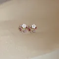 Floral wreath stud earrings featuring pink and purple crystals with white petals - Steel Post Stud (13)