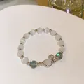 Elegant crystal beaded bracelet featuring iridescent stones and a silver heart-shaped charm. - Grey Moon Hollow Style (HB1324)