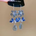 Close-up detail of luxury blue zircon dangling earrings with flower and butterfly charms - Dark Blue Floral Butterfly Style (22#)