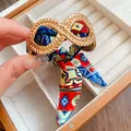 Close-up of exotic gold alloy bracelet with colorful ethnic pattern silk scarf ribbon. - Gold Bangle with Multicolor Scarf