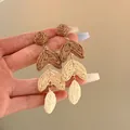 Detail view of multi-tiered raffia earrings featuring hand-woven brown and cream textures. - Color-blocking Contrast Style (10#)