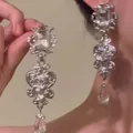 Detailed close-up view of ornate silver palace style earrings with sparkling clear crystals - Long Rectangular Pendant Style (10#)