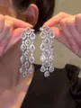 Detailed close-up view of elegant sparkling zircon water-drop tassel earrings held by hand - Three-row Symmetrical Tassel Style (15#)