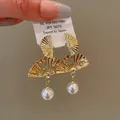 Vintage gold-plated fan-shaped earrings with elegant pearls and intricate engraved details - 29# Fan-Shaped Artificial Pearl Style