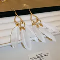 Elegant Bohemian teardrop earrings featuring white feather tassels and gold plating - Code 10 (Gold/White)