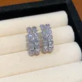 Close-up of elegant double-row zirconia hoop earrings in a cream jewelry box - Double Row Oval Hoop Style / Silver